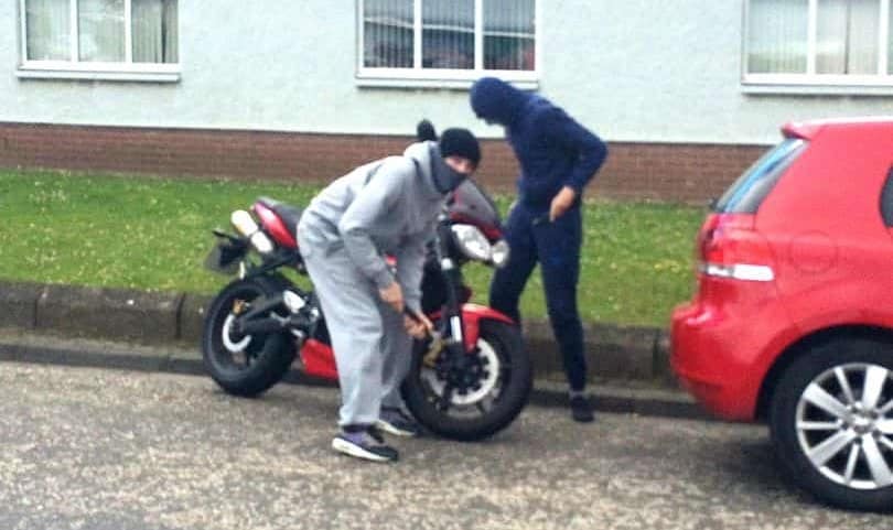 Men stealing motorbike