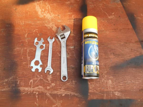 Tools for adjusting motorcycle chain tension